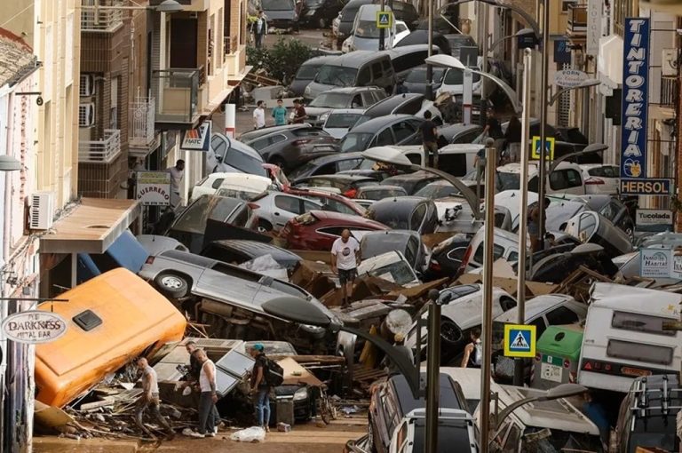 Vehicles piled up on a street following the intense rainfall and flooding in Valencia, Spain.