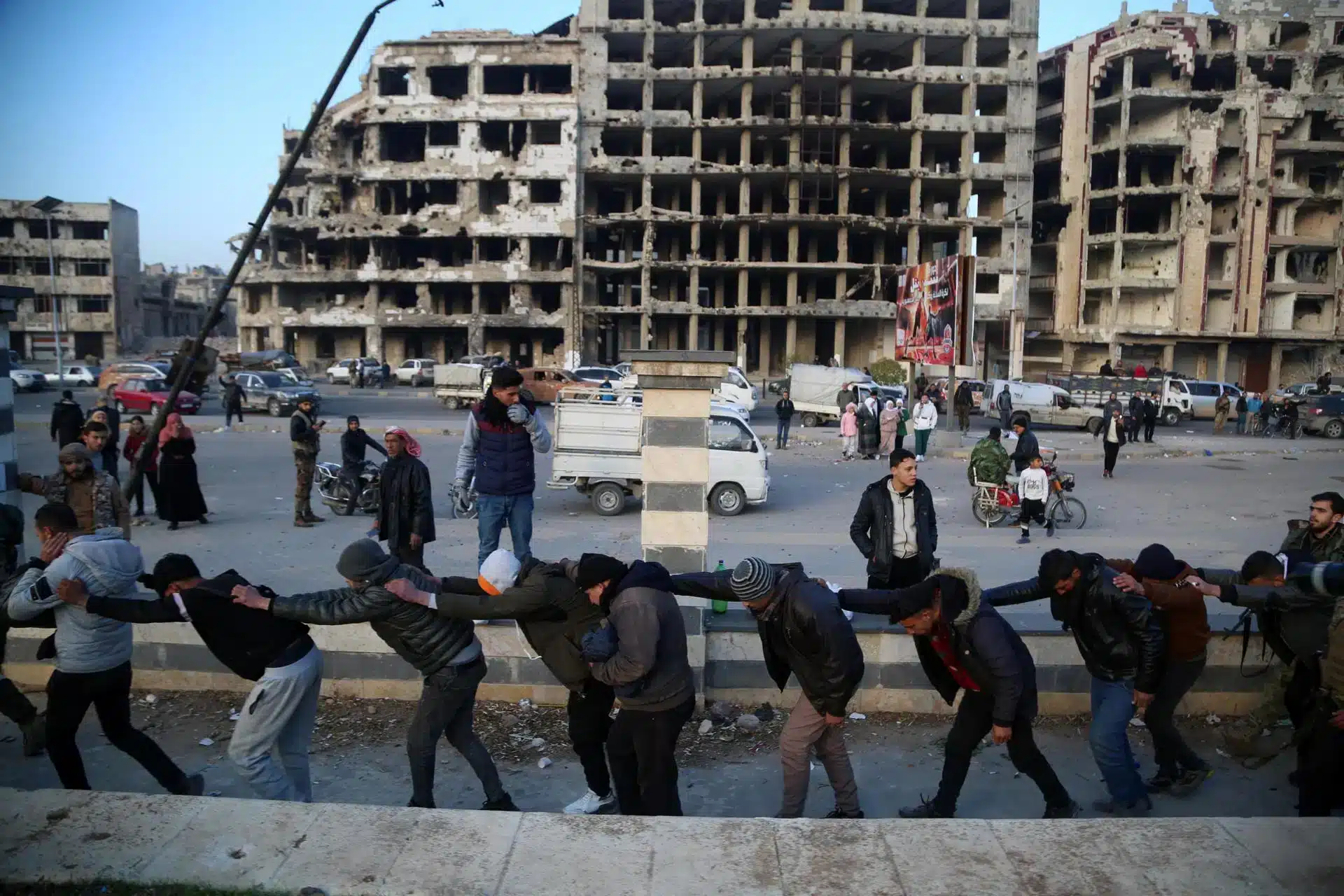 Syrian regime soldiers are transferred by rebel soldiers in Homs.